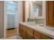 Elegant bathroom with wood cabinets, marble countertop, and walk-in shower at 4706 Warrior Se Way, Mableton, GA 30126