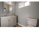 Modern bathroom with gray vanity, updated fixtures, and a large mirror at 4706 Warrior Se Way, Mableton, GA 30126