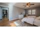 Spacious bedroom with ceiling fan, hardwood floors, and access to another room at 4706 Warrior Se Way, Mableton, GA 30126