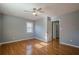 Bedroom with hardwood floors, ceiling fan and access to hallway at 4706 Warrior Se Way, Mableton, GA 30126