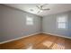 Bright, spacious bedroom with hardwood floors, two windows, and a ceiling fan at 4706 Warrior Se Way, Mableton, GA 30126