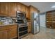 A classic kitchen showcases stainless steel appliances and ample wood cabinetry at 4706 Warrior Se Way, Mableton, GA 30126