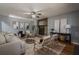 Relaxing living room features a stone fireplace, ceiling fan, and neutral-toned decor at 4706 Warrior Se Way, Mableton, GA 30126