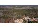 Aerial view of a wooded property featuring a well-maintained home and mature trees in a desirable neighborhood at 1560 Tapestry Rdg, Lawrenceville, GA 30045