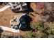 Aerial view showcases the home's roofline, driveway, and surrounding trees at 1560 Tapestry Rdg, Lawrenceville, GA 30045