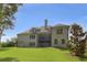 Spacious backyard featuring a two-story deck, lush lawn, and serene landscaping at 1560 Tapestry Rdg, Lawrenceville, GA 30045
