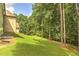 Expansive backyard with lush green lawn and mature trees providing ample shade at 1560 Tapestry Rdg, Lawrenceville, GA 30045