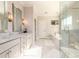 Bright main bathroom featuring dual sinks, marble countertops, a glass-enclosed shower, and a soaking tub at 1560 Tapestry Rdg, Lawrenceville, GA 30045