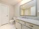 Bathroom with a marble countertop, large mirror, white cabinets, and white tiled floor at 1560 Tapestry Rdg, Lawrenceville, GA 30045