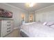 Well-lit bedroom with a serene ambiance, featuring a TV and dresser at 1560 Tapestry Rdg, Lawrenceville, GA 30045