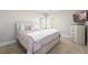 Cozy bedroom with a comfortable bed, neutral tones, and natural light at 1560 Tapestry Rdg, Lawrenceville, GA 30045
