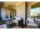 Inviting covered deck featuring a ceiling fan, comfortable seating, and scenic views at 1560 Tapestry Rdg, Lawrenceville, GA 30045