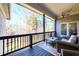 Charming covered deck offers comfortable seating and a tranquil view of the wooded backyard at 1560 Tapestry Rdg, Lawrenceville, GA 30045