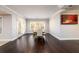 Bright dining room with hardwood floors and large windows, featuring a table and chairs perfect for Gathering meals or entertaining guests at 1560 Tapestry Rdg, Lawrenceville, GA 30045