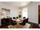 Elegant dining room featuring a white marble table with gold accents, plush chairs, and hardwood floors at 1560 Tapestry Rdg, Lawrenceville, GA 30045