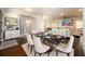Dining room with marble table, white chairs, and a view into the living area for an open-concept feel at 1560 Tapestry Rdg, Lawrenceville, GA 30045