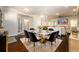 Open concept dining room featuring a marble table, upholstered chairs, and easy access to the living room at 1560 Tapestry Rdg, Lawrenceville, GA 30045