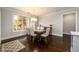 Elegant dining room with large picture window offering natural light, hardwood floors, and stylish decor at 1560 Tapestry Rdg, Lawrenceville, GA 30045