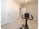 Well-lit exercise room featuring an exercise bike, neutral paint, and carpeted floors, perfect for staying active at home at 1560 Tapestry Rdg, Lawrenceville, GA 30045