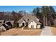Charming home exterior with a stone and brick facade, manicured lawn, and a curved driveway at 1560 Tapestry Rdg, Lawrenceville, GA 30045