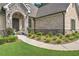 Inviting front entrance with stone archway, detailed brickwork, and manicured landscaping at 1560 Tapestry Rdg, Lawrenceville, GA 30045