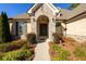 Charming brick home featuring a meticulously landscaped front yard and arched entryway with double doors at 1560 Tapestry Rdg, Lawrenceville, GA 30045
