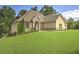 Beautiful brick home featuring manicured landscaping and a well-maintained lawn at 1560 Tapestry Rdg, Lawrenceville, GA 30045