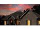 Stunning home exterior with stone and brick details illuminated at dusk at 1560 Tapestry Rdg, Lawrenceville, GA 30045