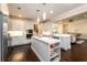 Contemporary kitchen with stainless steel refrigerator, island with marble countertop, and open floorplan at 1560 Tapestry Rdg, Lawrenceville, GA 30045