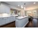 Open kitchen features a center island, stainless steel dishwasher, dark hardwood floors and eat-in dining area at 1560 Tapestry Rdg, Lawrenceville, GA 30045
