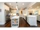 Bright, open kitchen featuring a large island, stainless steel appliances, and sleek white cabinetry at 1560 Tapestry Rdg, Lawrenceville, GA 30045