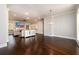 Open concept living room with hardwood floors, crown molding, and a view of the fireplace and television at 1560 Tapestry Rdg, Lawrenceville, GA 30045