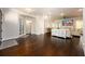 Open concept living area and dining room with hardwood floors, modern lighting, and a cozy fireplace at 1560 Tapestry Rdg, Lawrenceville, GA 30045