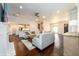 Spacious living room with hardwood floors, fireplace, and open floor plan featuring neutral-toned furniture at 1560 Tapestry Rdg, Lawrenceville, GA 30045