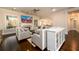 Bright living room with a fireplace, hardwood floors, neutral furniture, and natural light from large windows at 1560 Tapestry Rdg, Lawrenceville, GA 30045