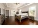 Bright main bedroom with hardwood floors, neutral tones, ceiling fan, and large windows providing ample natural light at 1560 Tapestry Rdg, Lawrenceville, GA 30045