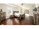 Spacious main bedroom with hardwood floors, tray ceiling, and lots of natural light from multiple windows at 1560 Tapestry Rdg, Lawrenceville, GA 30045