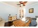 Sunlit home office featuring a ceiling fan, wood floors, built in cabinet and french doors at 1560 Tapestry Rdg, Lawrenceville, GA 30045
