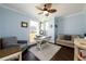Home office with blue walls, a ceiling fan, hardwood floors, and a window view at 1560 Tapestry Rdg, Lawrenceville, GA 30045