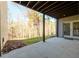 Spacious concrete patio with wooded views, perfect for outdoor gatherings and relaxation at 1560 Tapestry Rdg, Lawrenceville, GA 30045