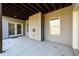 Covered concrete patio offering ample space and featuring neutral colored siding at 1560 Tapestry Rdg, Lawrenceville, GA 30045