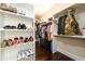 Organized walk-in closet with built-in shelving and hanging rods for optimal storage at 1560 Tapestry Rdg, Lawrenceville, GA 30045