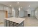 Open-concept kitchen with island flows into a living room with a fireplace and staircase at 246 Arnewood Cir, Mcdonough, GA 30253