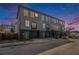 Three-story townhome featuring gray siding, black brick accents, and teal doors and balcony trim at 93 Terry Se St # A, Atlanta, GA 30312