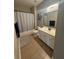 Bathroom with a tub-shower combo, single sink vanity with lots of storage, and tile flooring at 1074 Bradshaw Estates Dr, Canton, GA 30115