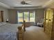 Bright bedroom with a tray ceiling, a ceiling fan, and a large window at 1074 Bradshaw Estates Dr, Canton, GA 30115