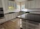 Modern kitchen featuring white cabinets, granite countertops, and stainless steel appliances at 1074 Bradshaw Estates Dr, Canton, GA 30115