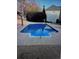 A bright blue inground pool with a manicured yard and a suburban home in the background at 1074 Bradshaw Estates Dr, Canton, GA 30115