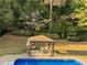 Backyard featuring a clear blue swimming pool, well-manicured lawn, and gazebo at 1074 Bradshaw Estates Dr, Canton, GA 30115