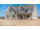 Two-story farmhouse with gray siding, stone accents, and a covered porch at 1414 Alcovy Station Rd, Covington, GA 30014